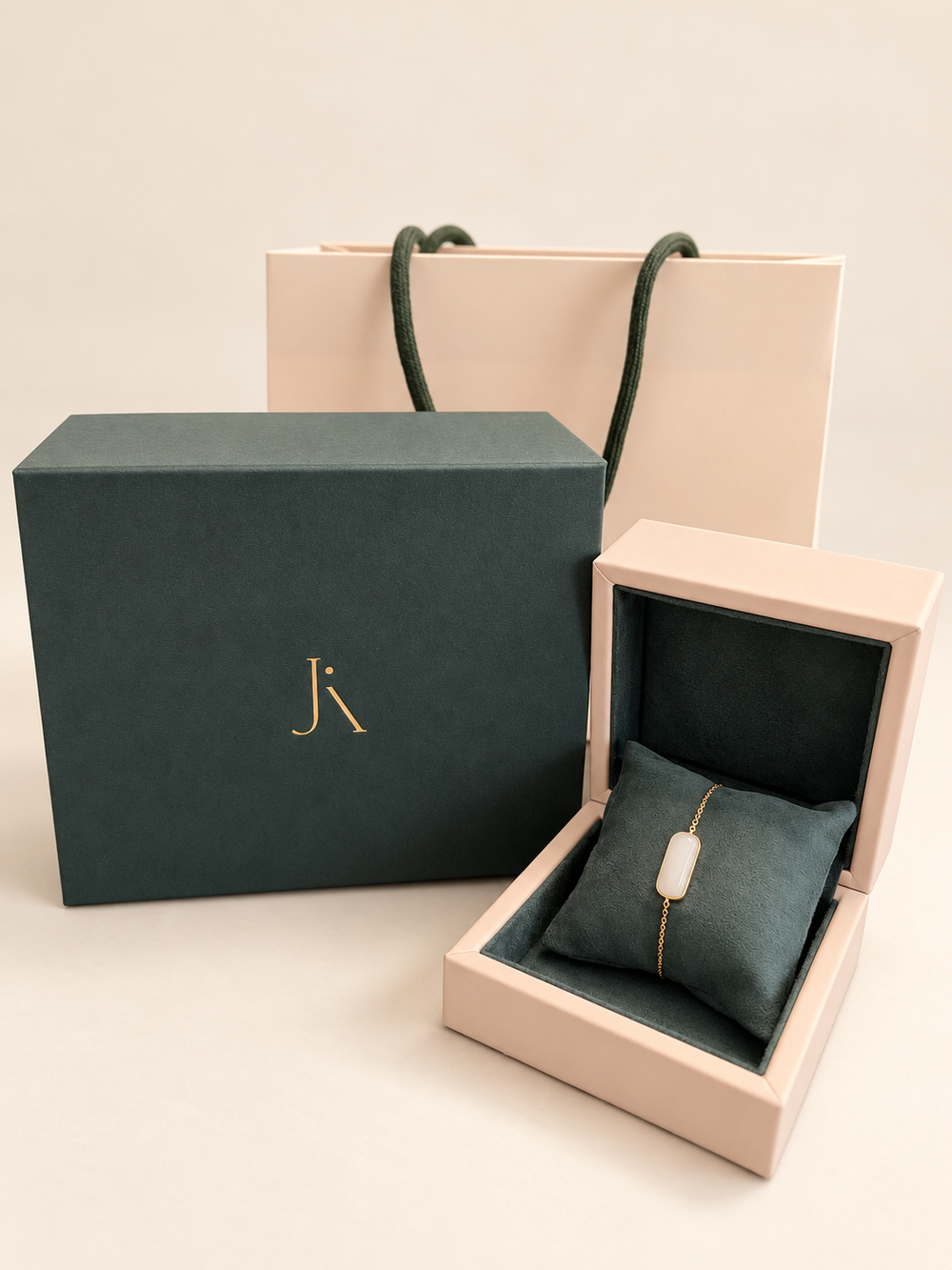 Jade Aura gift bag, green gift box and open jewellery box with the Line Bar Bracelet